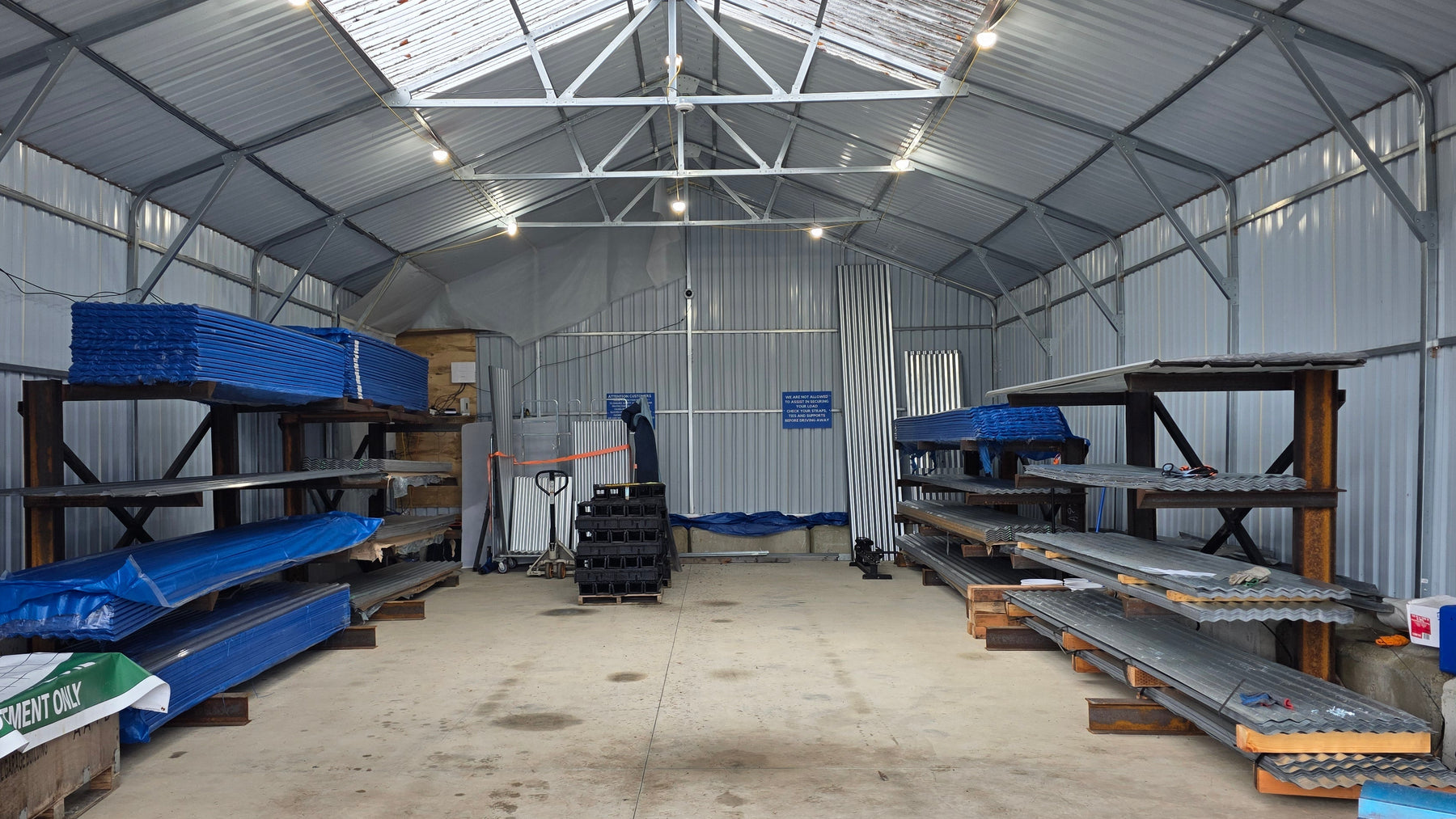 Interior of the Valley Outdoor Supply large warehouse with stocked metal shelves and equipment.